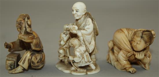 A Japanese ivory netsuke and two similar okimono